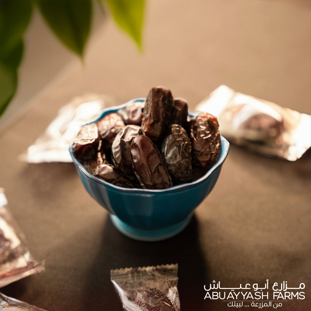 1 Kg Individually Wrapped Delicious Kala Dates in a dish from AbuAyyash Farms